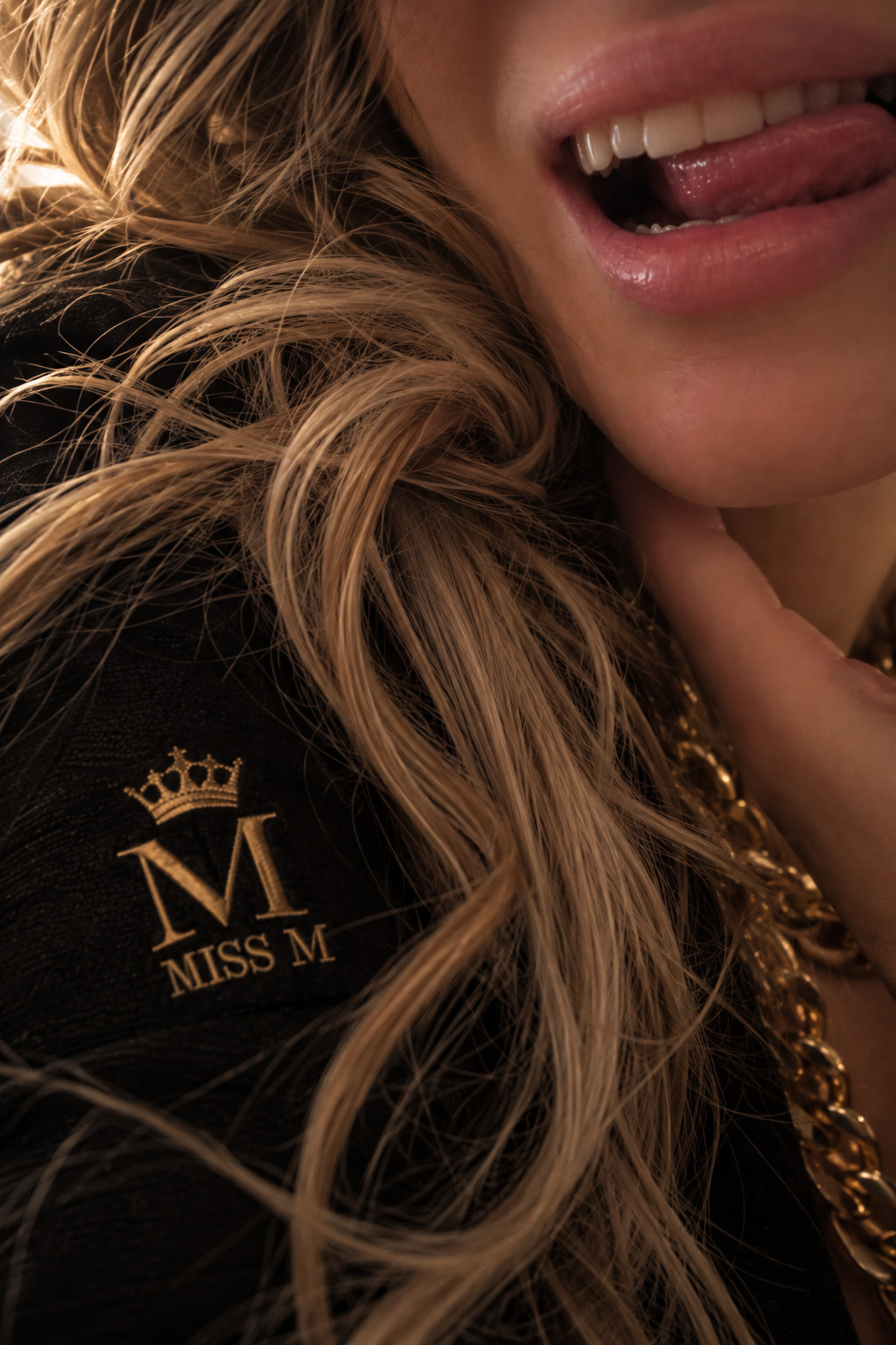 A close-up of Miss M’s smile and signature shirt